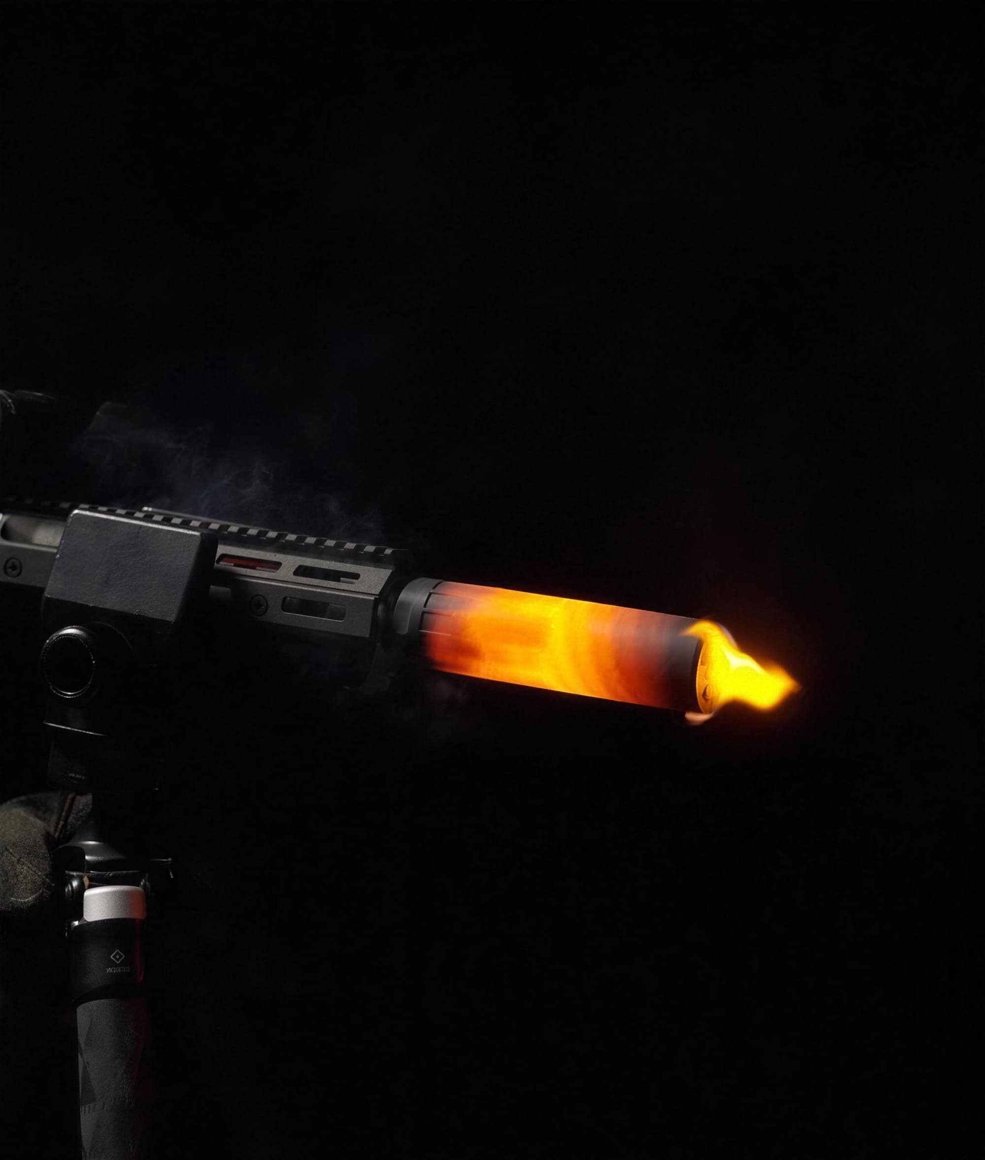 Blackbird suppressor glowing orange-hot under sustained fire, night test